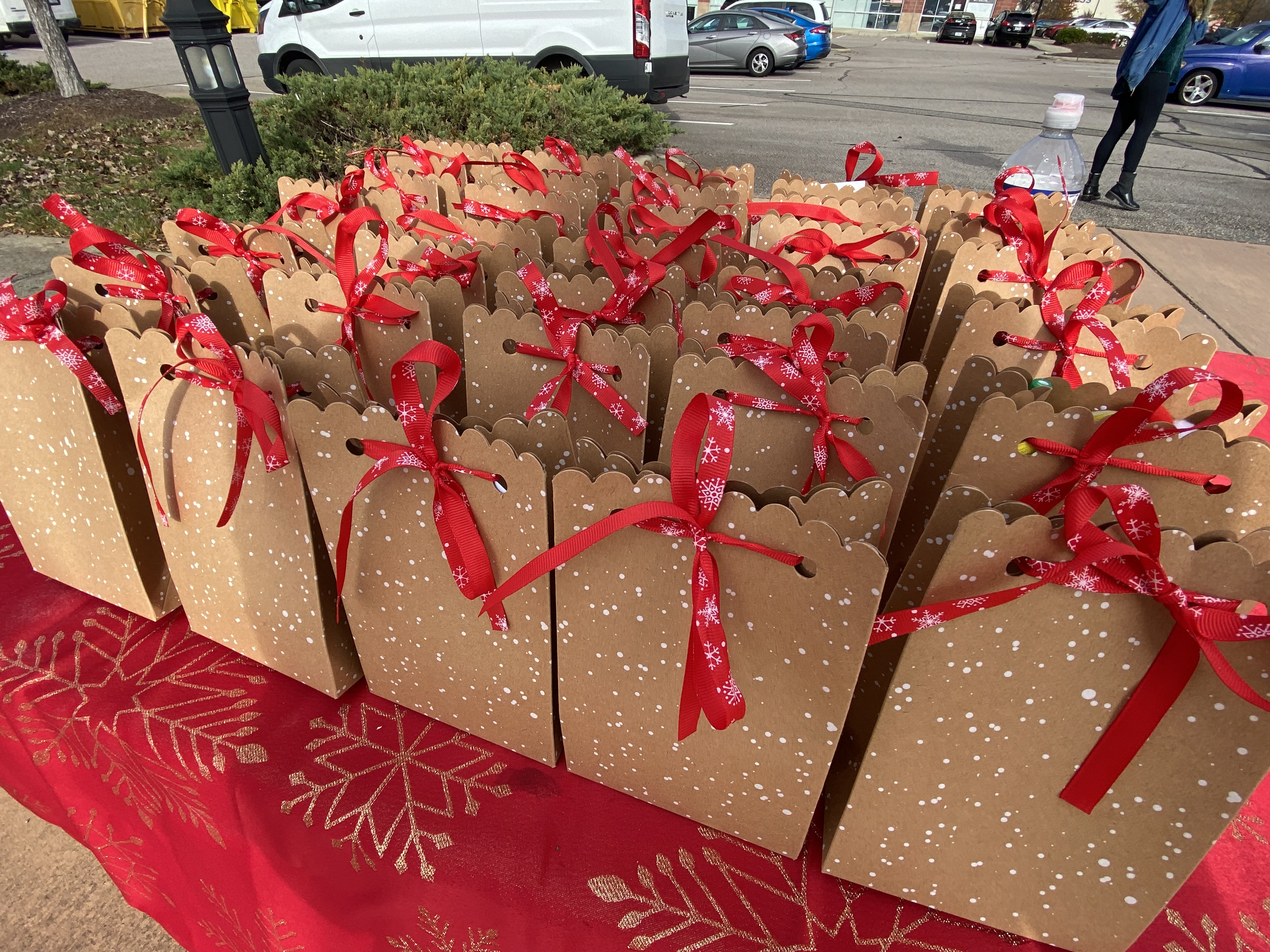 Grab bag Christmas presents with a red boy on a table